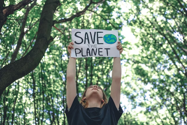 A man holds a motivational poster calling for saving the planet